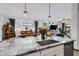 Island kitchen with granite countertops and sink, open to living room at 369 W Glacier Bay Dr, San Tan Valley, AZ 85140