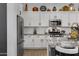 Kitchen boasts granite countertops, white cabinets, and stainless steel appliances at 369 W Glacier Bay Dr, San Tan Valley, AZ 85140
