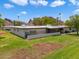 Rear view of home, grassy area, and mountain backdrop at 6056 E Harvard St, Scottsdale, AZ 85257