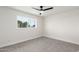 Bedroom with grey carpet, ceiling fan and window at 6056 E Harvard St, Scottsdale, AZ 85257