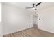 Bright bedroom with light walls, wood-look flooring, and ceiling fan at 6056 E Harvard St, Scottsdale, AZ 85257
