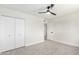 Bedroom with white closet doors and grey carpet at 6056 E Harvard St, Scottsdale, AZ 85257