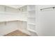 Large walk-in closet with custom shelving and hanging rods at 6056 E Harvard St, Scottsdale, AZ 85257