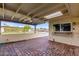 Covered patio with brick pavers, ceiling fan, and view of the backyard at 6056 E Harvard St, Scottsdale, AZ 85257