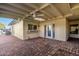 Covered patio with brick pavers, ceiling fan, and access to the backyard at 6056 E Harvard St, Scottsdale, AZ 85257