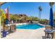 Community pool with patio furniture and mountain views at 6056 E Harvard St, Scottsdale, AZ 85257