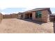 Spacious backyard with a covered patio, privacy wall, and room to customize at 7674 W Cactus Wren Way, Florence, AZ 85132
