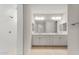 Bathroom featuring double sinks, quartz countertop, white cabinetry, walk-in shower, and large mirror at 7674 W Cactus Wren Way, Florence, AZ 85132