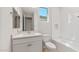 Modern bathroom with white tile, vanity, toilet, and bathtub combination at 7674 W Cactus Wren Way, Florence, AZ 85132