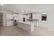 Modern kitchen featuring white cabinets, stainless steel appliances, and a spacious center island at 7674 W Cactus Wren Way, Florence, AZ 85132