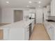 Open kitchen design with a large island, stainless steel appliances, and ample counter space at 7674 W Cactus Wren Way, Florence, AZ 85132