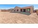 Spacious dirt backyard with a covered patio and block fence at 7682 W Mockingbird Way, Florence, AZ 85132