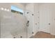 Modern bathroom with a glass shower, white marble style tiling, a built in shower bench, and matte black hardware at 7682 W Mockingbird Way, Florence, AZ 85132
