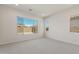 Minimalist bedroom design with neutral carpet and neighborhood views from two large windows, maximizing natural light at 7682 W Mockingbird Way, Florence, AZ 85132
