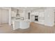 Spacious kitchen with white cabinetry, center island, stainless steel appliances, and decorative backsplash at 7682 W Mockingbird Way, Florence, AZ 85132