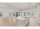 Open concept kitchen features a white island, stainless steel appliances, and views of the spacious dining and living areas at 7682 W Mockingbird Way, Florence, AZ 85132