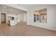 Spacious open layout combining kitchen and living spaces, flooded with natural light, plus light-colored floors throughout at 7682 W Mockingbird Way, Florence, AZ 85132