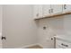 Laundry room with overhead cabinets and countertop space at 7682 W Mockingbird Way, Florence, AZ 85132