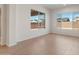 Bright living room with wood-style floors and large windows offering neighborhood views, plus recessed ceiling lights at 7682 W Mockingbird Way, Florence, AZ 85132
