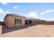 Backyard featuring a covered patio and the exterior of a home with a tile roof at 7736 W Mockingbird Way, Florence, AZ 85132