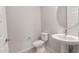 Powder room with pedestal sink and round mirror, next to a closed door at 7736 W Mockingbird Way, Florence, AZ 85132