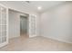 Bedroom featuring tile floors, neutral colored walls, and double doors at 7736 W Mockingbird Way, Florence, AZ 85132