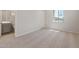 Bright bedroom with natural light and carpeted floor, adjacent to a bathroom at 7736 W Mockingbird Way, Florence, AZ 85132