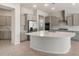 Open kitchen with stainless steel appliances, a large island, and gray cabinets at 7736 W Mockingbird Way, Florence, AZ 85132
