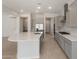 Bright kitchen with a large island featuring a sink, stainless steel appliances, and ample cabinet space at 7736 W Mockingbird Way, Florence, AZ 85132