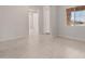 Bright living room featuring neutral walls, tiled floors, and a window with a stone surround at 7736 W Mockingbird Way, Florence, AZ 85132