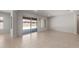 Spacious living room featuring a sliding glass door leading to the backyard patio at 7736 W Mockingbird Way, Florence, AZ 85132