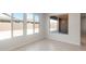 Bright, airy living room with large windows and tile flooring, perfect for natural light at 7736 W Mockingbird Way, Florence, AZ 85132