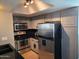 Modern kitchen with stainless steel appliances and dark gray cabinetry at 1720 E Thunderbird Rd # 2015, Phoenix, AZ 85022