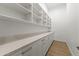 Bright pantry with white cabinets and quartz countertops at 18232 W Rancho Ct, Litchfield Park, AZ 85340