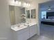 Bathroom with dual sinks, modern fixtures, and decor; Primary bedroom is in the background at 26722 N 174Th Ln, Surprise, AZ 85387