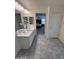 Bathroom with dual sinks leading into the Primary bedroom, tiled floors and modern fixtures at 26722 N 174Th Ln, Surprise, AZ 85387
