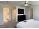 Serene bedroom with a mounted TV, dresser, and access to the bathroom creating a restful space at 26722 N 174Th Ln, Surprise, AZ 85387