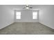 Well-lit bedroom with ceiling fan and carpeted floor at 26722 N 174Th Ln, Surprise, AZ 85387