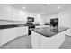 Modern kitchen with white cabinets, granite counters, and island at 26722 N 174Th Ln, Surprise, AZ 85387