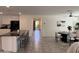 Well-lit kitchen with an island, modern appliances, and an open view to the dining and living areas at 26722 N 174Th Ln, Surprise, AZ 85387