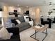 Comfortable living room with a plush sofa, stylish seating, and an open view to the modern kitchen at 26722 N 174Th Ln, Surprise, AZ 85387