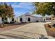 Front view of a charming house with a large driveway and mature trees at 320 S 70Th St # 36, Mesa, AZ 85208