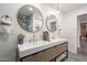 Modern bathroom with double vanity, gold fixtures, and large mirrors at 3436 E Fairmount Ave, Phoenix, AZ 85018