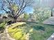 Landscaped backyard with grassy area and mature trees at 5431 E Shea Blvd, Scottsdale, AZ 85254
