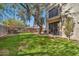 Green grassy backyard with mature trees and home view at 6002 N 5Th Pl, Phoenix, AZ 85012