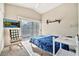 Comfortable guest bedroom with a rocking chair and access to a balcony at 6002 N 5Th Pl, Phoenix, AZ 85012