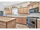 Spacious kitchen with an island, stainless steel appliances, and light wood cabinets at 6002 N 5Th Pl, Phoenix, AZ 85012