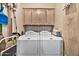 Convenient laundry room with washer, dryer, and overhead cabinets at 6002 N 5Th Pl, Phoenix, AZ 85012