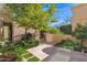 Landscaped courtyard with lush greenery, a gate and stone pathway at 6701 N Scottsdale Rd # 24, Scottsdale, AZ 85250