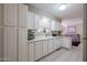 White kitchen cabinets, ample counter space, and view to living room at 11452 N 109Th Ave, Sun City, AZ 85351